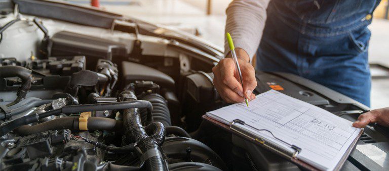 mechanic testing car for its MOT